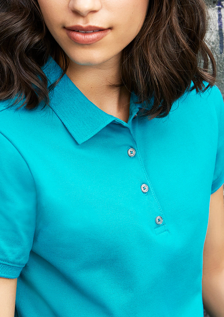 Image showing a woman in an UrbanTee Cotton Women's Polo at a cafe.