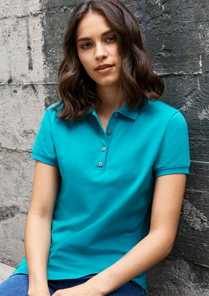 Image showing a woman in an UrbanTee Cotton Women's Polo at a cafe.