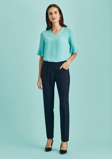 Image showing a woman in a professional setting wearing Women's Bandless Slim Leg Pants.