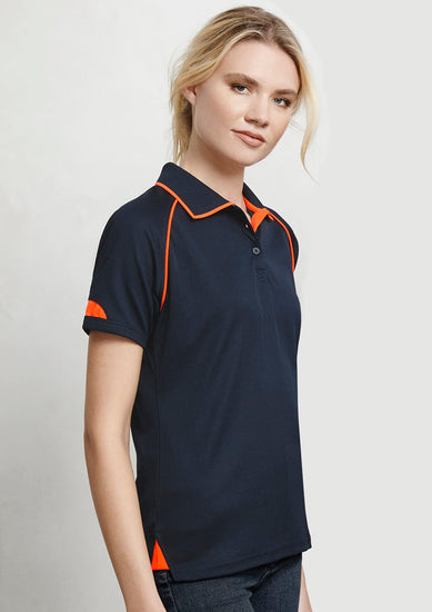 Image of a woman wearing an Emporio Quick Dry Women's Polo at a summer festival.