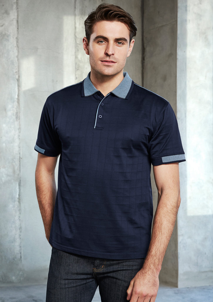 Image of a man wearing a Cole Self Check Fabric Men's Polo in a corporate setting.